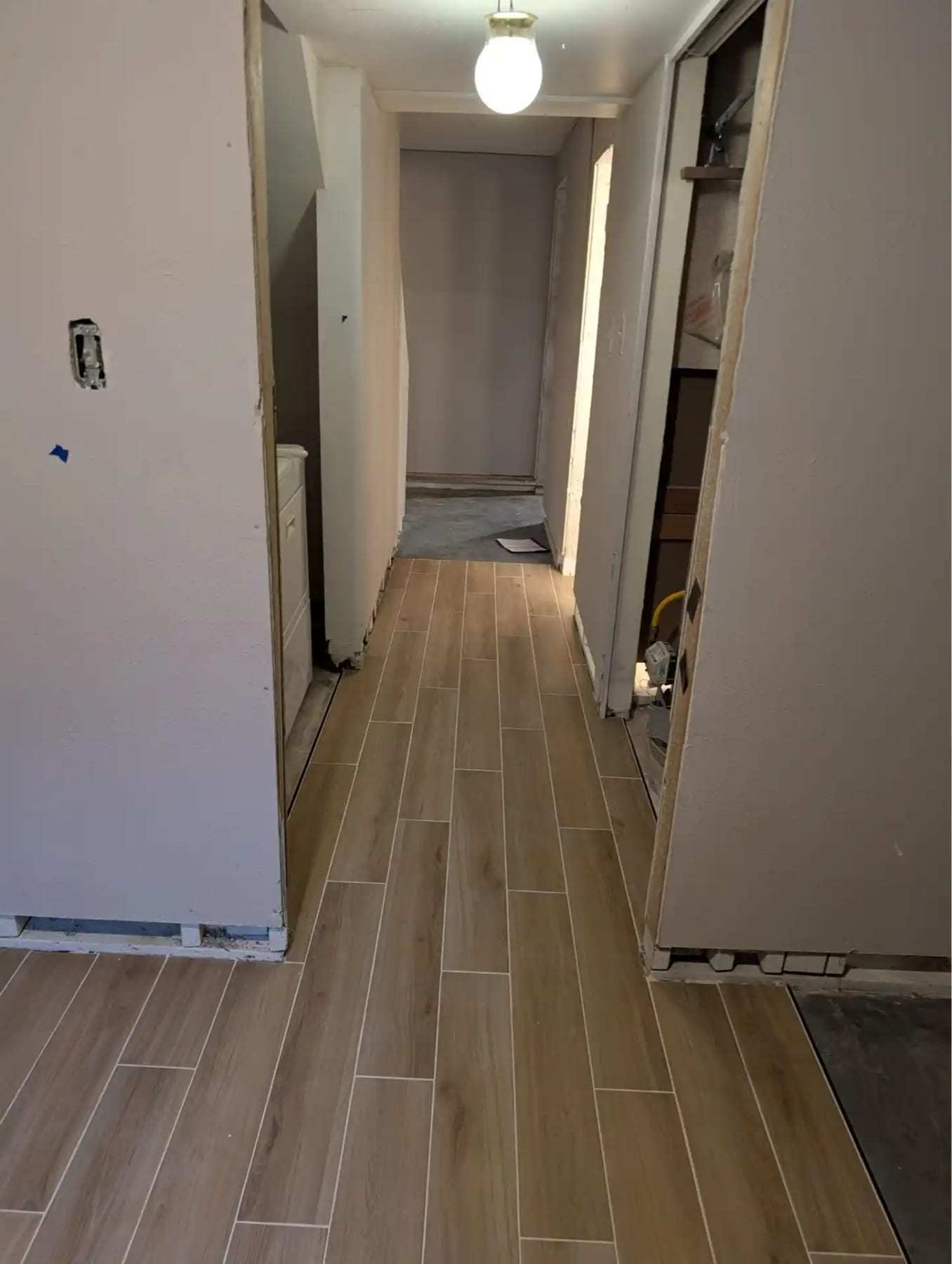 Hallway with new plank flooring installed after repairs